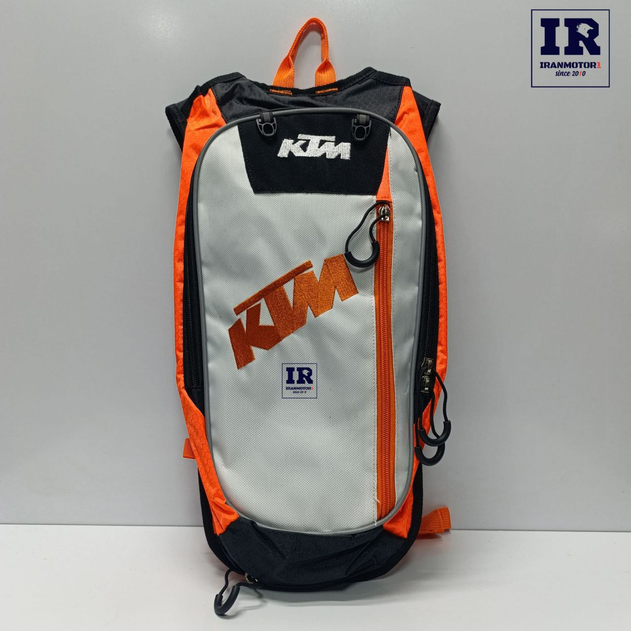 image_1770654516581 کوله پشتی کمل بک کی تی ام KTM سفید نارنجی - تصویر 1